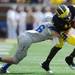 Air Force defensive back Gavin McHenry wraps up Michigan wide receiver Devin Gardner during the first half at Michigan Stadium on Saturday. Melanie Maxwell I AnnArbor.com
